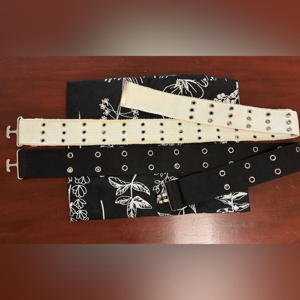 EUC Two small belts with multiple rows of holes for sizing. Black and white.